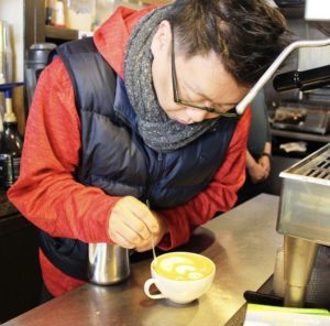 Joseph making a latte at Coffee Nature