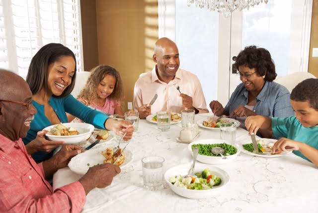 Multi Generation Family Enjoying Meal At Home